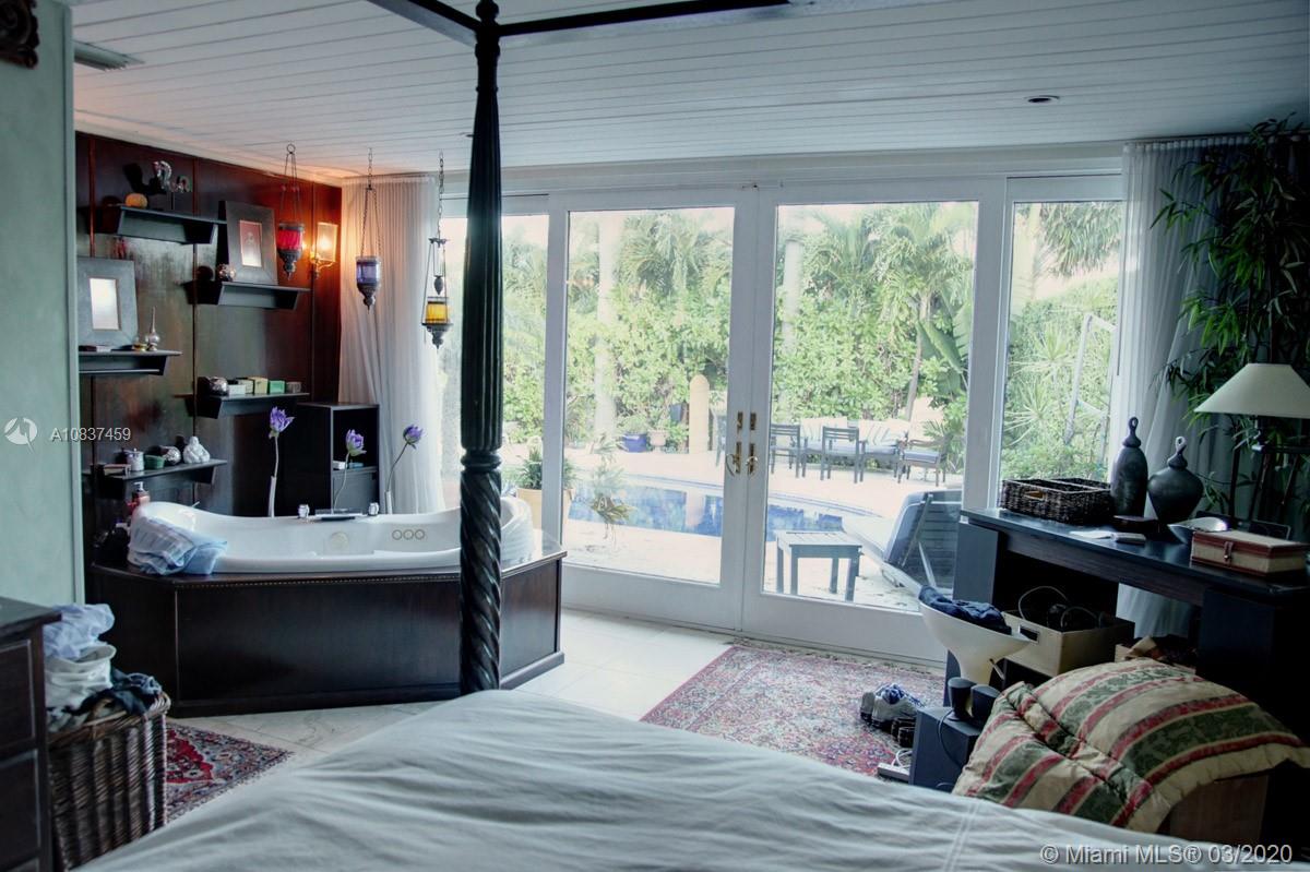 7975 Biscayne Point Circle Miami Beach, FL 33141 - Photo 27 of 34 a living room with furniture and a large window