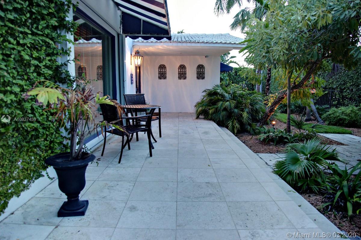 7975 Biscayne Point Circle Miami Beach, FL 33141 - Photo 3 of 34 a view of a patio with table and chairs and potted plants