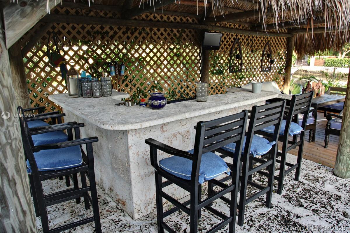 7975 Biscayne Point Circle Miami Beach, FL 33141 - Photo 9 of 34 a view of a dinning table and chairs in the patio
