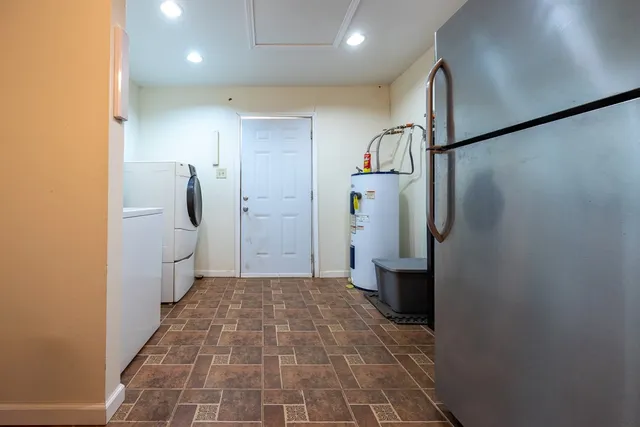 a spacious bathroom with a double vanity sink a toilet and a mirror