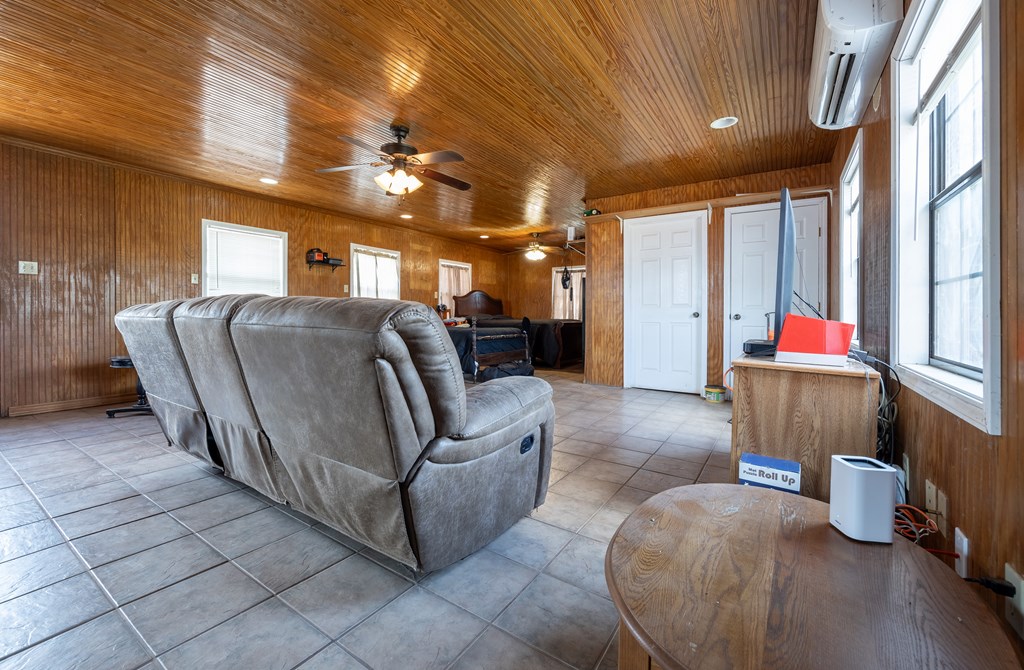 1596 Mule Creek Road Robert Lee, TX 76945 - Photo 17 of 98 a living room with furniture and a chandelier