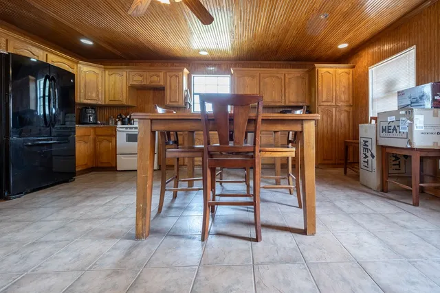 a bathroom with a granite countertop toilet sink and mirror