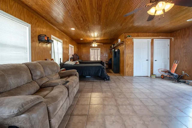 a kitchen with stainless steel appliances kitchen island granite countertop a stove a sink a dining table and chairs