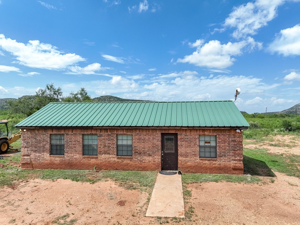 1596 Mule Creek Road Robert Lee, TX 76945 - Photo 2 of 98 a front view of a house with a yard and garage