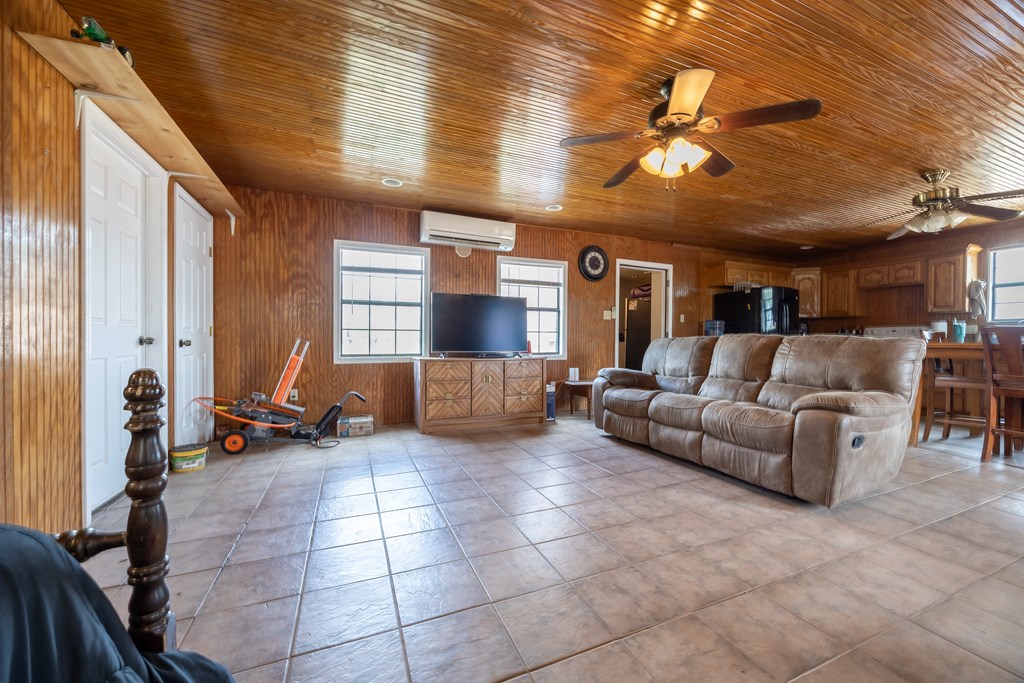 1596 Mule Creek Road Robert Lee, TX 76945 - Photo 21 of 98 a living room with furniture and a chandelier