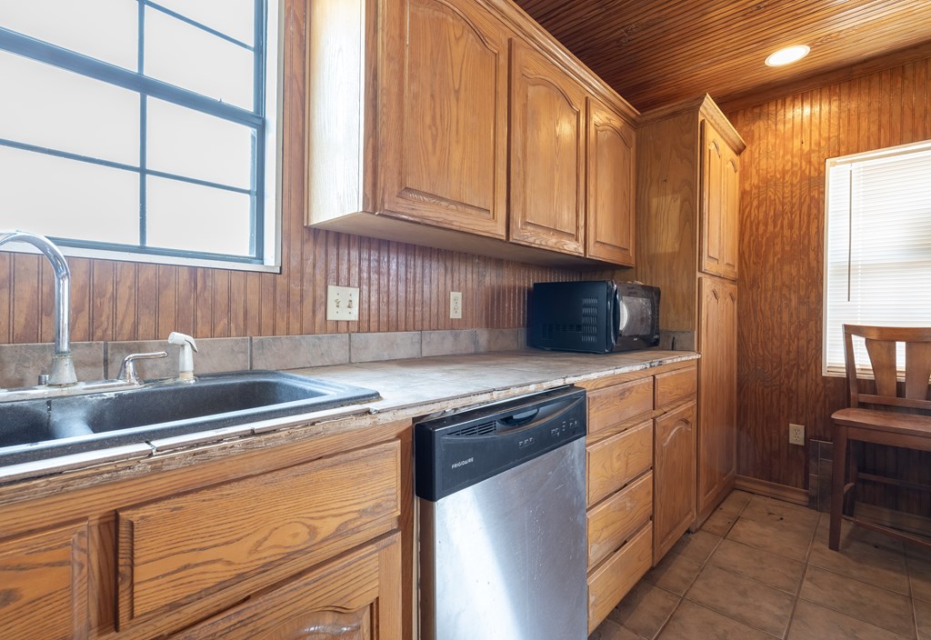 1596 Mule Creek Road Robert Lee, TX 76945 - Photo 22 of 98 a kitchen with stainless steel appliances granite countertop a sink and a stove