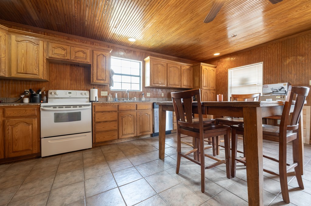 1596 Mule Creek Road Robert Lee, TX 76945 - Photo 23 of 98 a kitchen with a stove a table and chairs in it