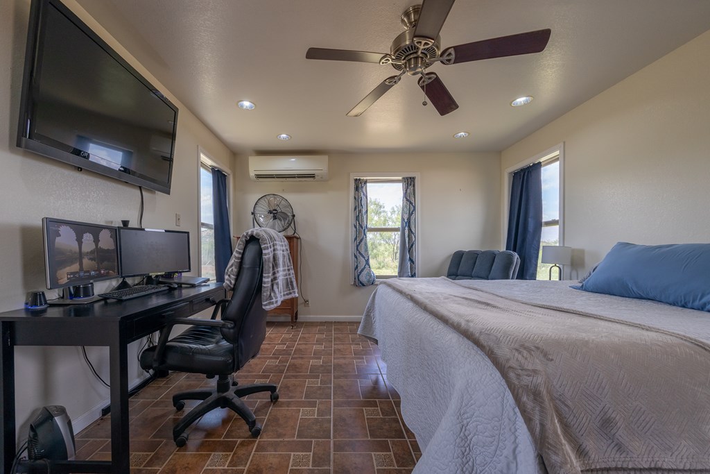1596 Mule Creek Road Robert Lee, TX 76945 - Photo 25 of 98 a bed room with furniture and a flat screen tv