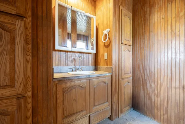 a view of a lush green forest with trees and some houses