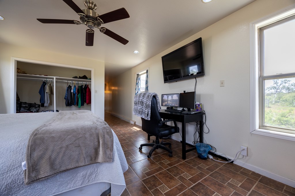 1596 Mule Creek Road Robert Lee, TX 76945 - Photo 41 of 98 a bedroom with a bed and a flat screen tv