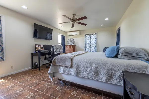 a living room with furniture a large window and a chandelier