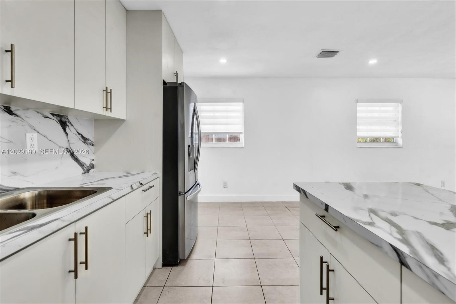 11790 Southwest 34th Street Miami, FL 33175 - Photo 19 of 56 a kitchen with a sink and cabinets