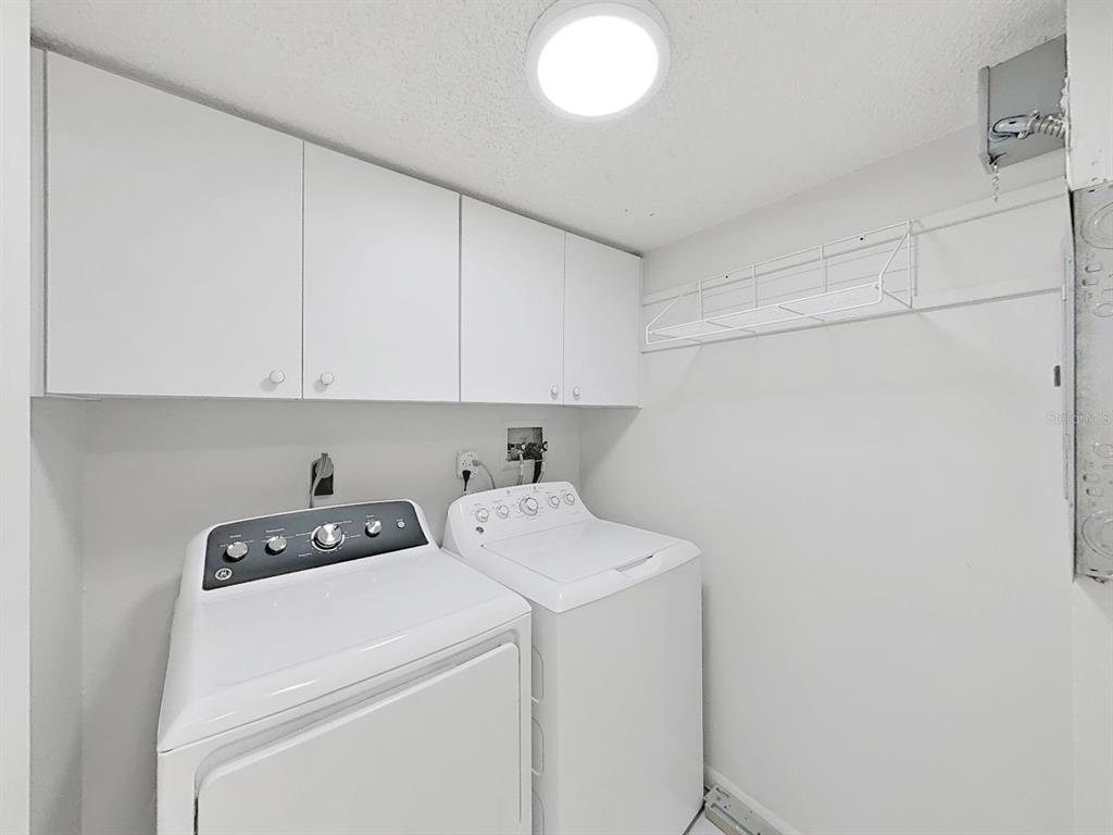 700 Starkey Road, Unit 511 Largo, FL 33771 - Photo 21 of 27 a view of storage and utility room with washer and dryer