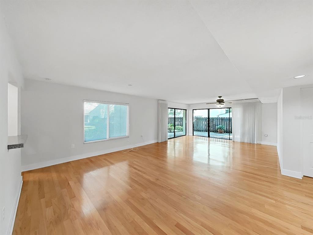 700 Starkey Road, Unit 511 Largo, FL 33771 - Photo 3 of 27 an empty room with wooden floor and windows
