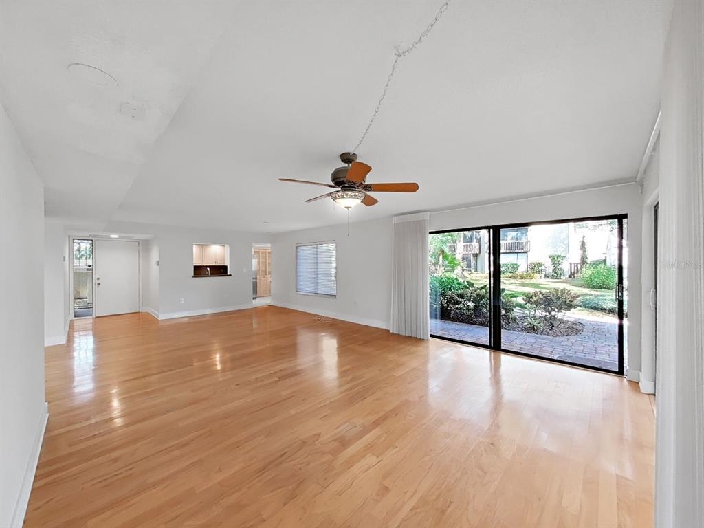 700 Starkey Road, Unit 511 Largo, FL 33771 - Photo 4 of 27 a view of empty room with wooden floor and fan