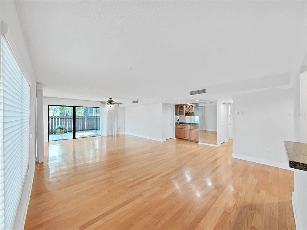 700 Starkey Road, Unit 511 Largo, FL 33771 - Photo 5 of 27 a view of empty room with wooden floor and fan