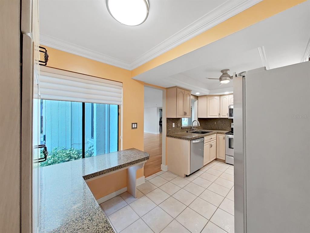 700 Starkey Road, Unit 511 Largo, FL 33771 - Photo 7 of 27 a kitchen with stainless steel appliances granite countertop a refrigerator and a stove top oven