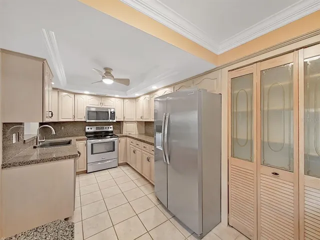 a large white kitchen with cabinets