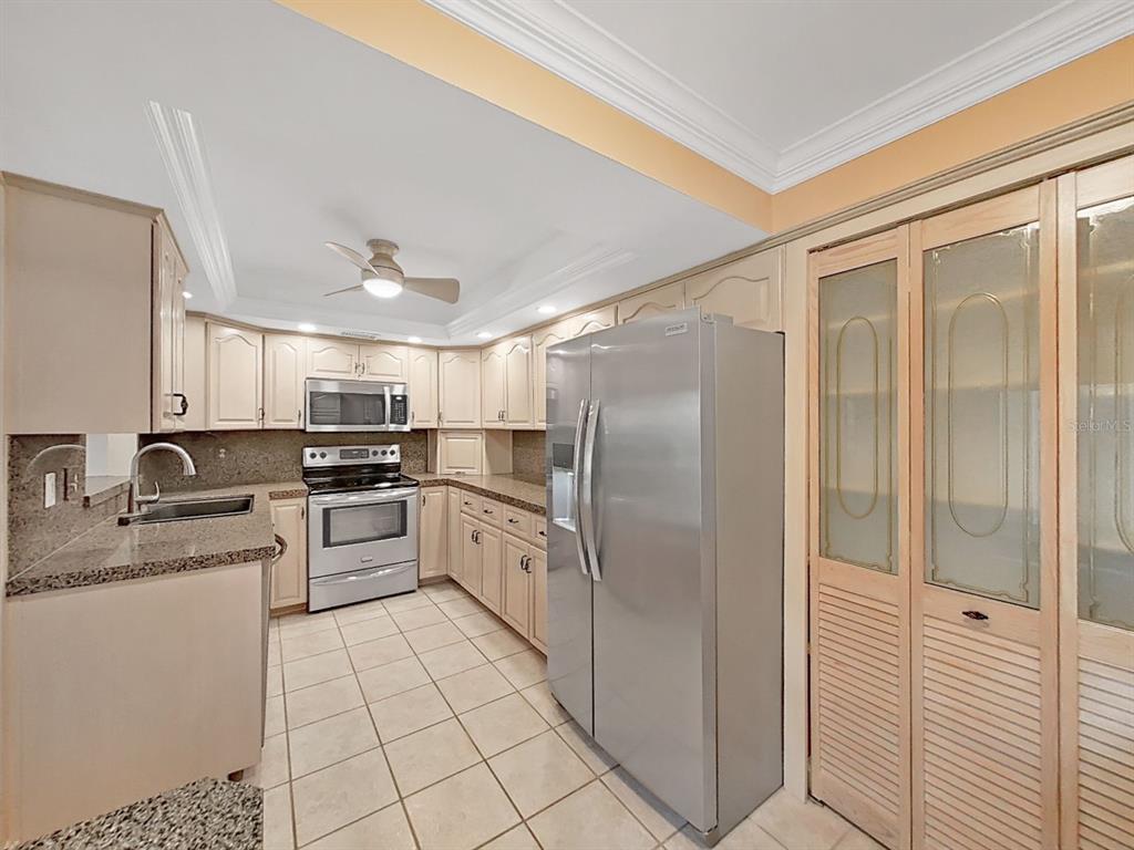 700 Starkey Road, Unit 511 Largo, FL 33771 - Photo 9 of 27 a large white kitchen with cabinets