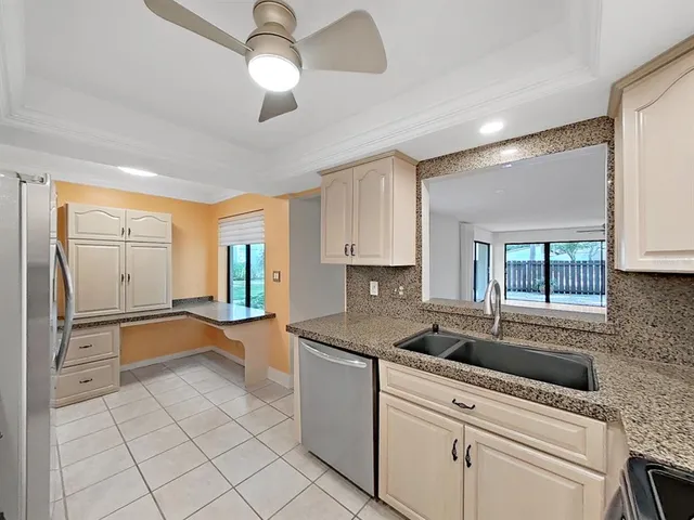 a kitchen with a sink appliances and cabinets