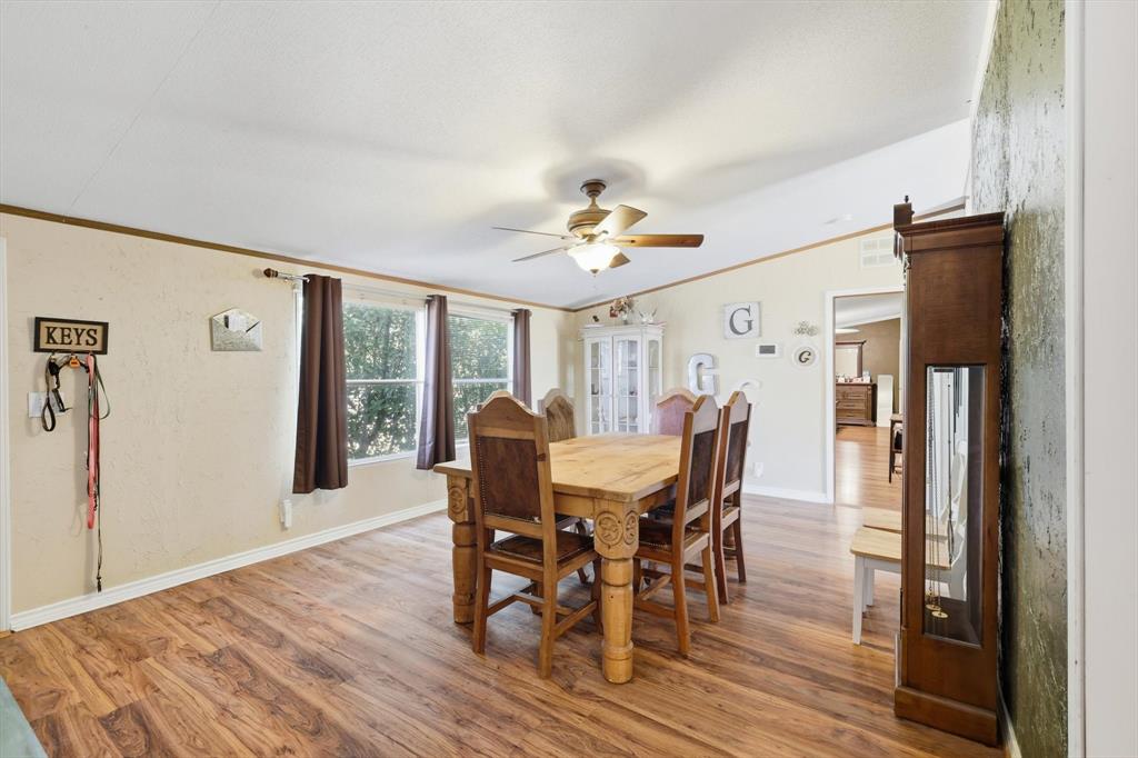 1200 Alliance Boulevard Rhome, TX 76078 - Photo 11 of 31 Dining area featuring light wood-style flooring, ornamental molding, and ceiling fan