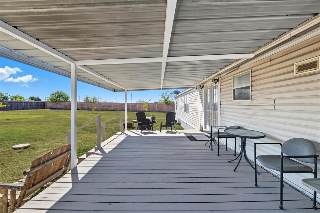 1200 Alliance Boulevard Rhome, TX 76078 - Photo 28 of 31 Wooden deck featuring a fenced backyard and outdoor dining space