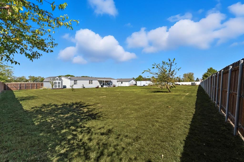 1200 Alliance Boulevard Rhome, TX 76078 - Photo 3 of 31 Fenced backyard featuring an outbuilding