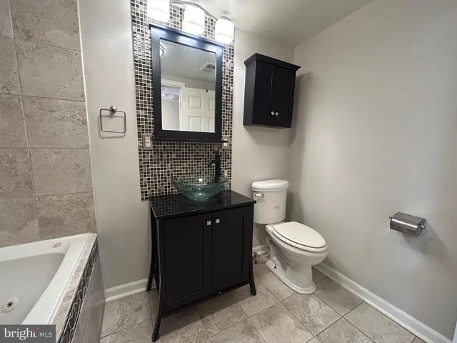 a bathroom with a bathtub and a sink