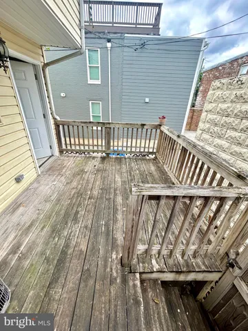 a backyard of a house with barbeque oven table and chairs