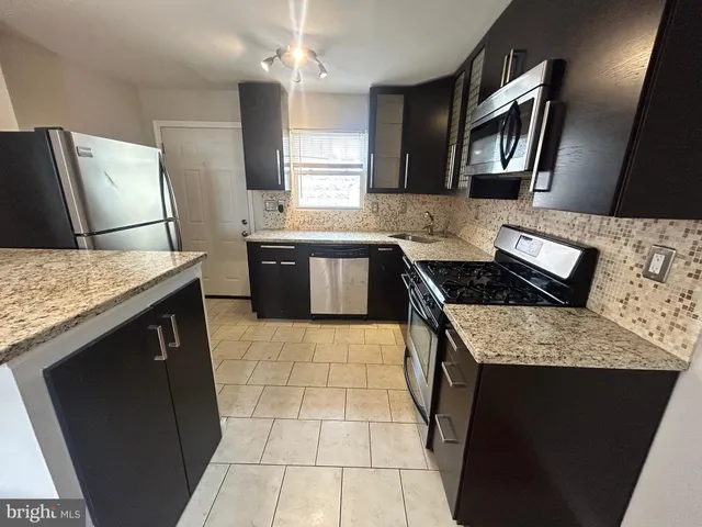a kitchen with a sink stove and refrigerator