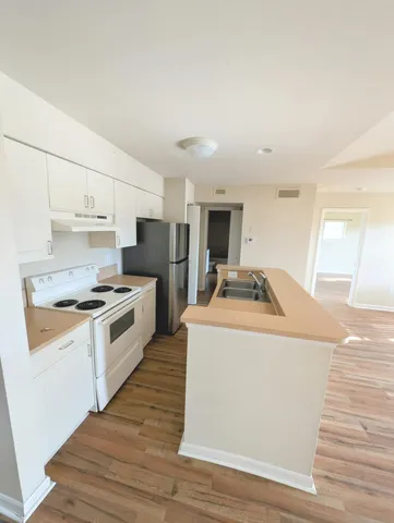 a kitchen with sink a stove and refrigerator