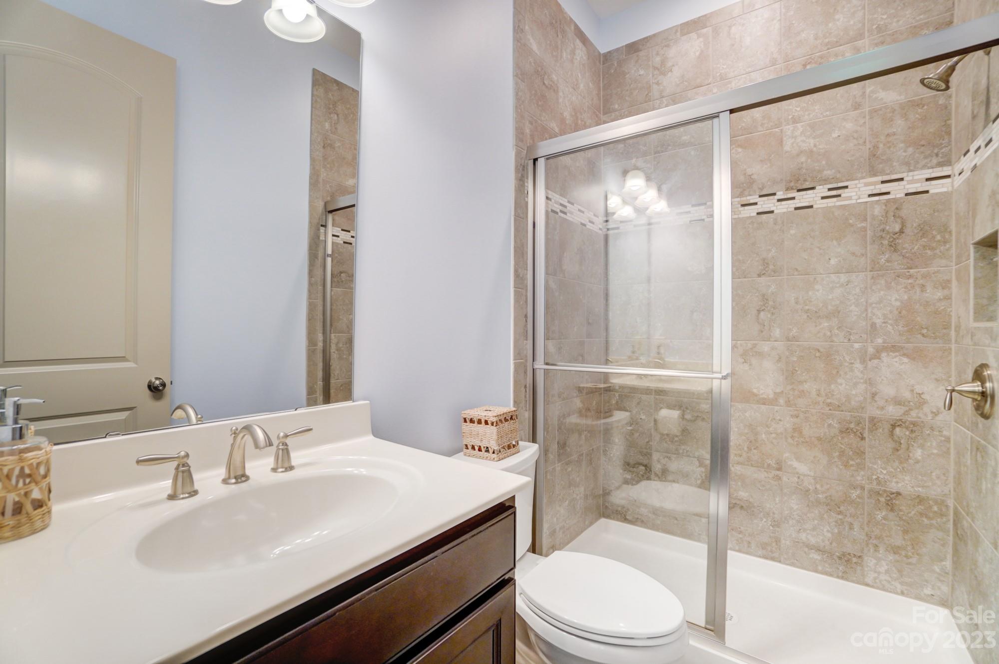 6030 Fallondale Road Waxhaw, NC 28173 - Photo 17 of 48 a bathroom with a sink toilet and shower
