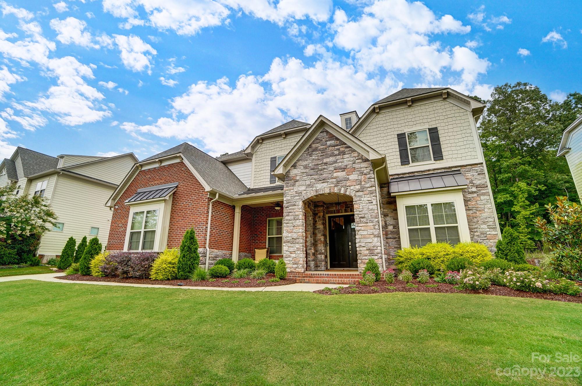 6030 Fallondale Road Waxhaw, NC 28173 - Photo 2 of 48 a front view of a house with garden