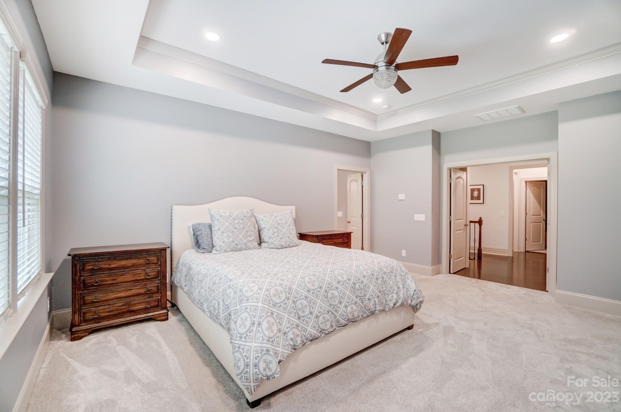 6030 Fallondale Road Waxhaw, NC 28173 - Photo 21 of 48 a bedroom with a bed and a ceiling fan