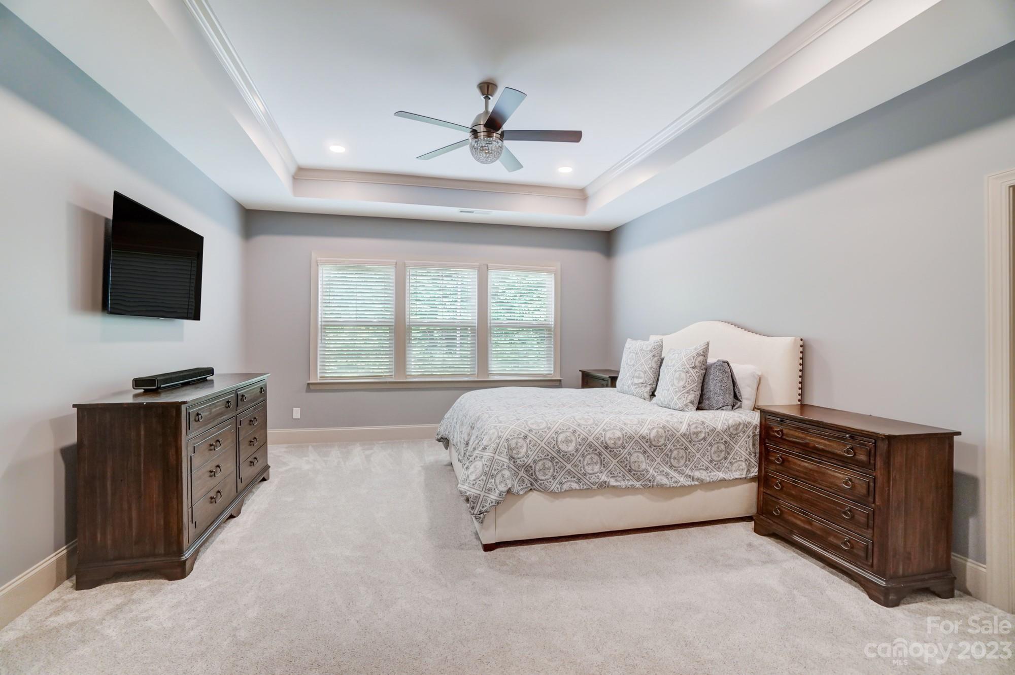 6030 Fallondale Road Waxhaw, NC 28173 - Photo 22 of 48 a spacious bedroom with a bed and a flat screen tv