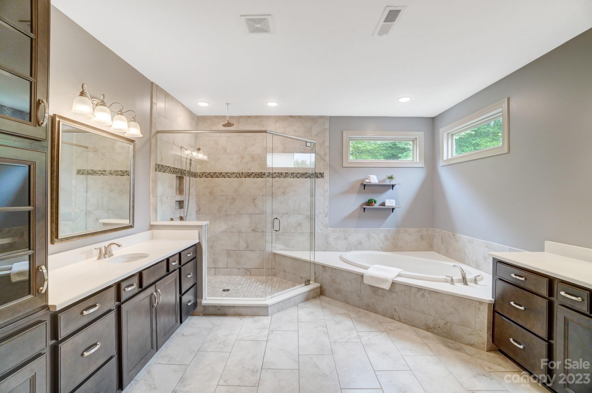 6030 Fallondale Road Waxhaw, NC 28173 - Photo 24 of 48 a spacious bathroom with a tub sink shower and mirror