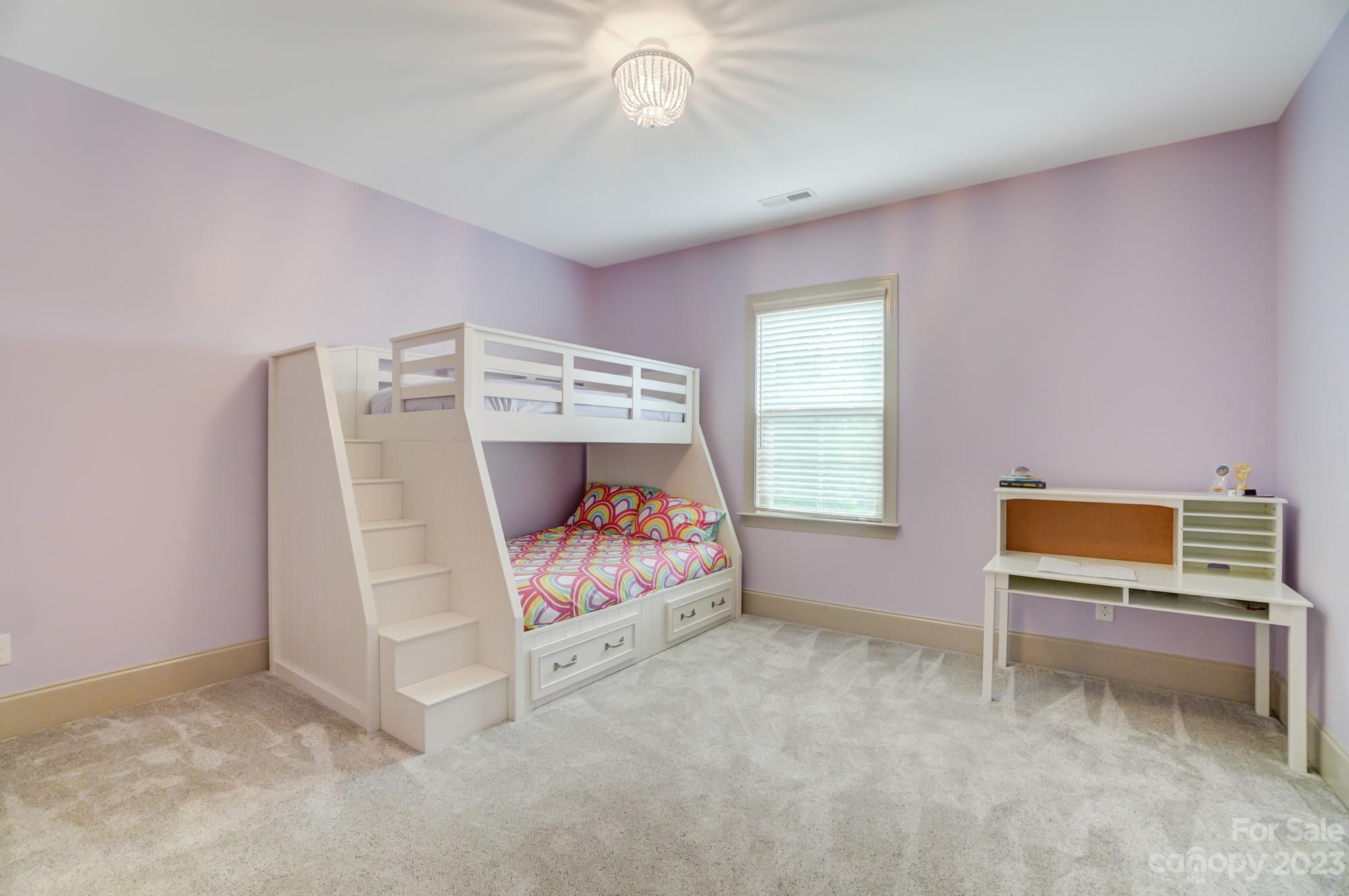 6030 Fallondale Road Waxhaw, NC 28173 - Photo 32 of 48 a bedroom with furniture and a chandelier