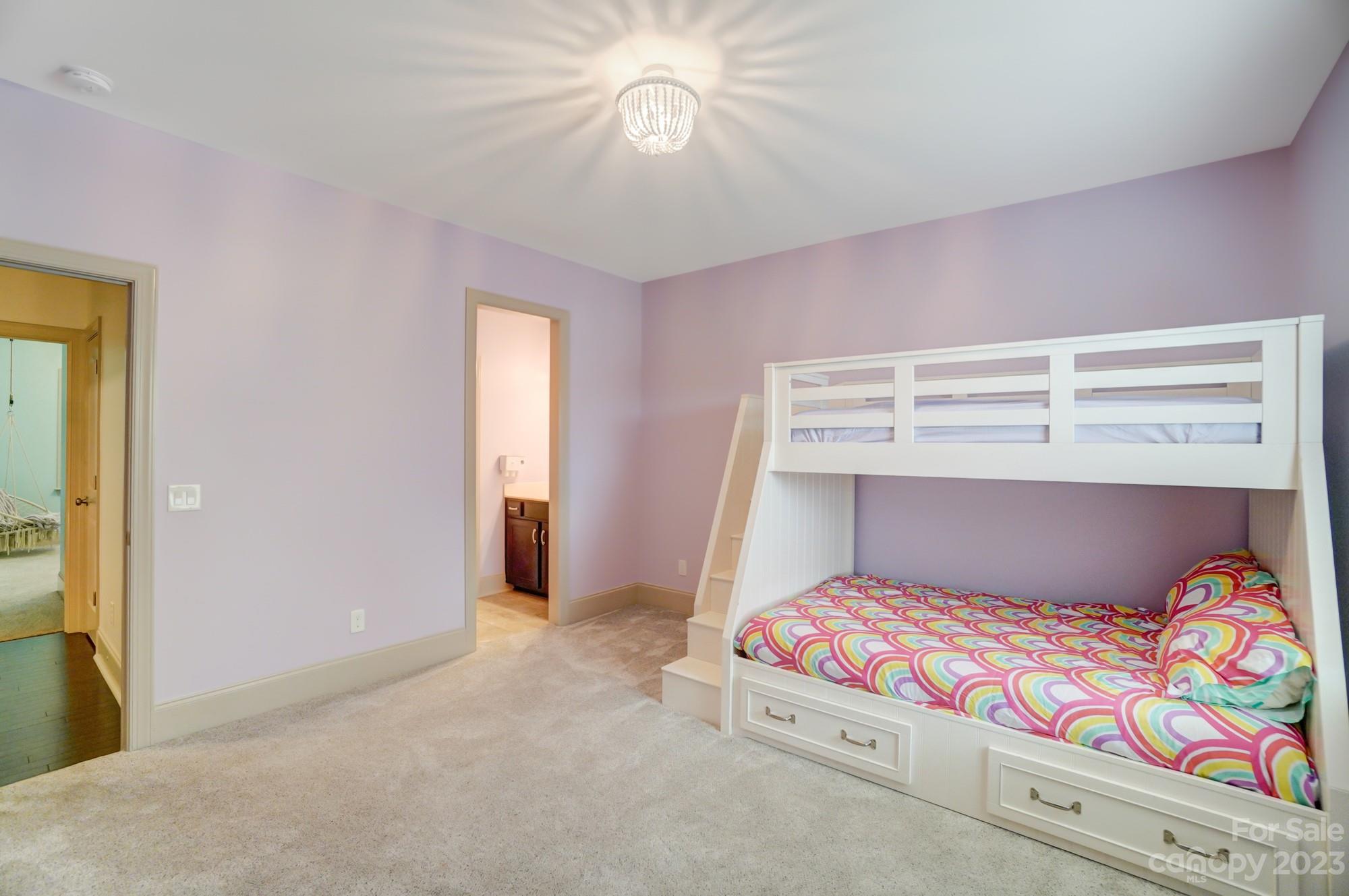 6030 Fallondale Road Waxhaw, NC 28173 - Photo 33 of 48 a bedroom with a bed and a chandelier