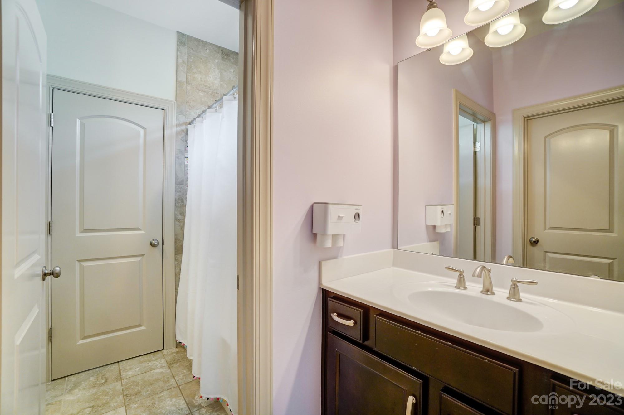 6030 Fallondale Road Waxhaw, NC 28173 - Photo 34 of 48 a bathroom with a sink vanity and a mirror