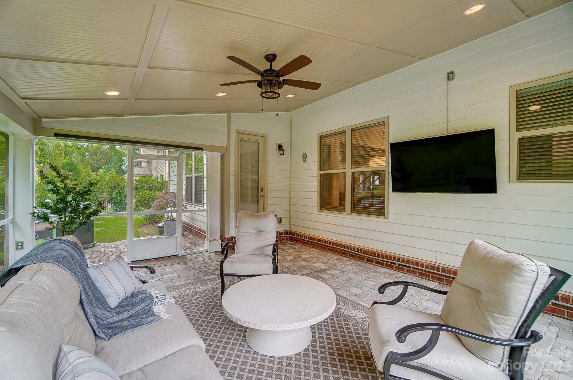 6030 Fallondale Road Waxhaw, NC 28173 - Photo 42 of 48 a living room with furniture a flat screen tv and a floor to ceiling window