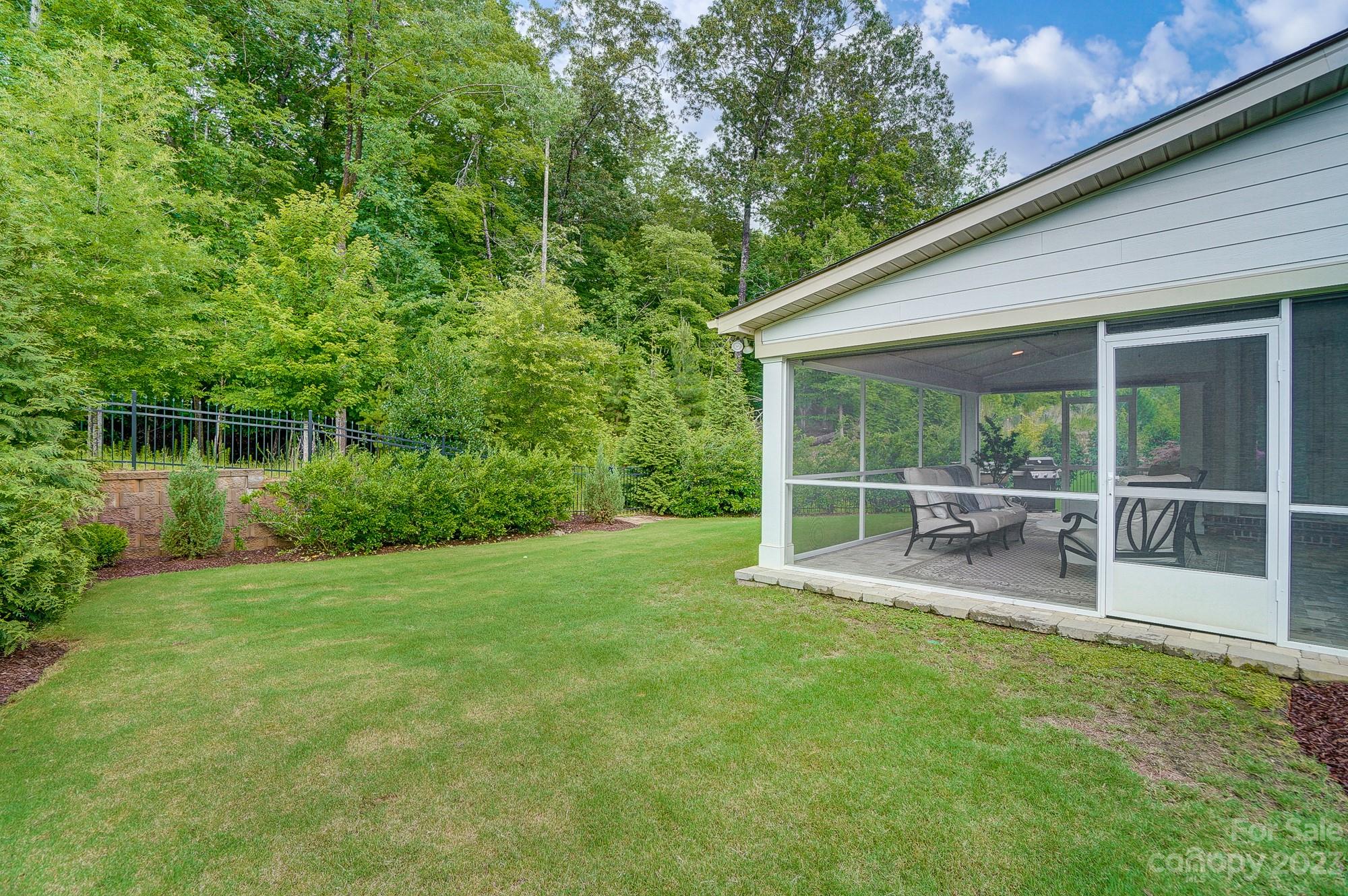 6030 Fallondale Road Waxhaw, NC 28173 - Photo 46 of 48 a view of a backyard with plants and large tree