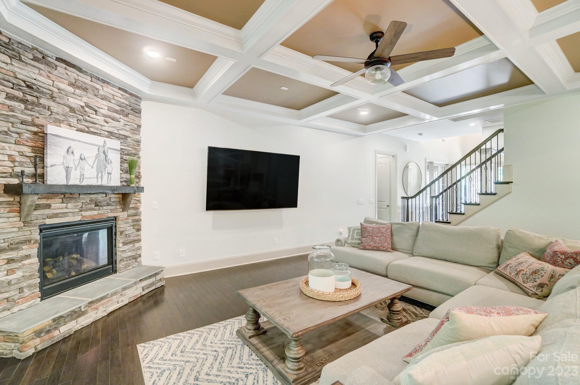 6030 Fallondale Road Waxhaw, NC 28173 - Photo 8 of 48 a living room with furniture a fireplace and a flat screen tv