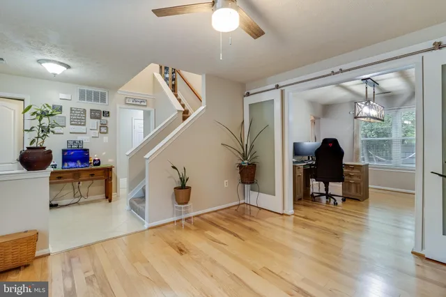 a workspace with wooden floor and windows