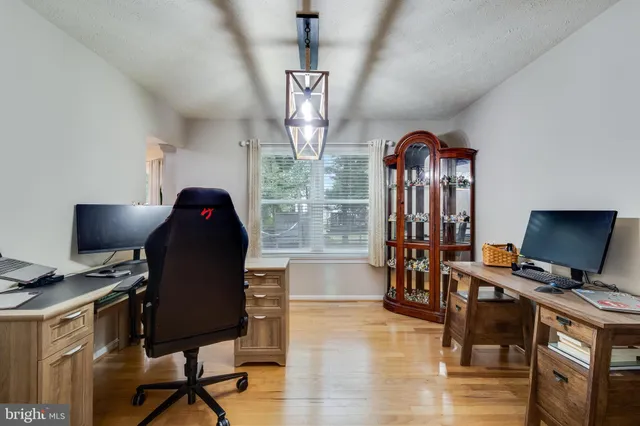 a workspace with furniture hardwood and a window