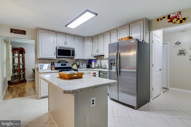 a kitchen with granite countertop a refrigerator and a sink