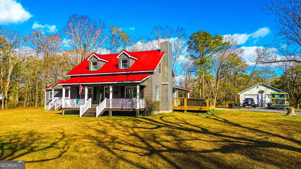 a view of a house with a yard patio and wooden floor