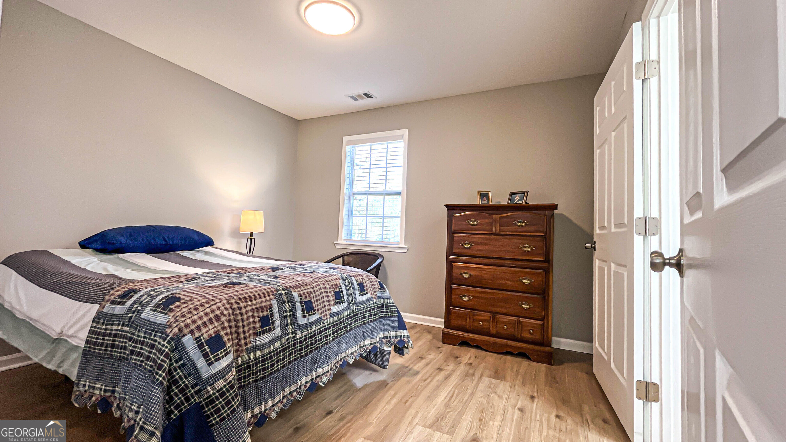 587 Highway 41 Milner, GA 30257 - Photo 102 of 172 a bedroom with a bed and a dresser