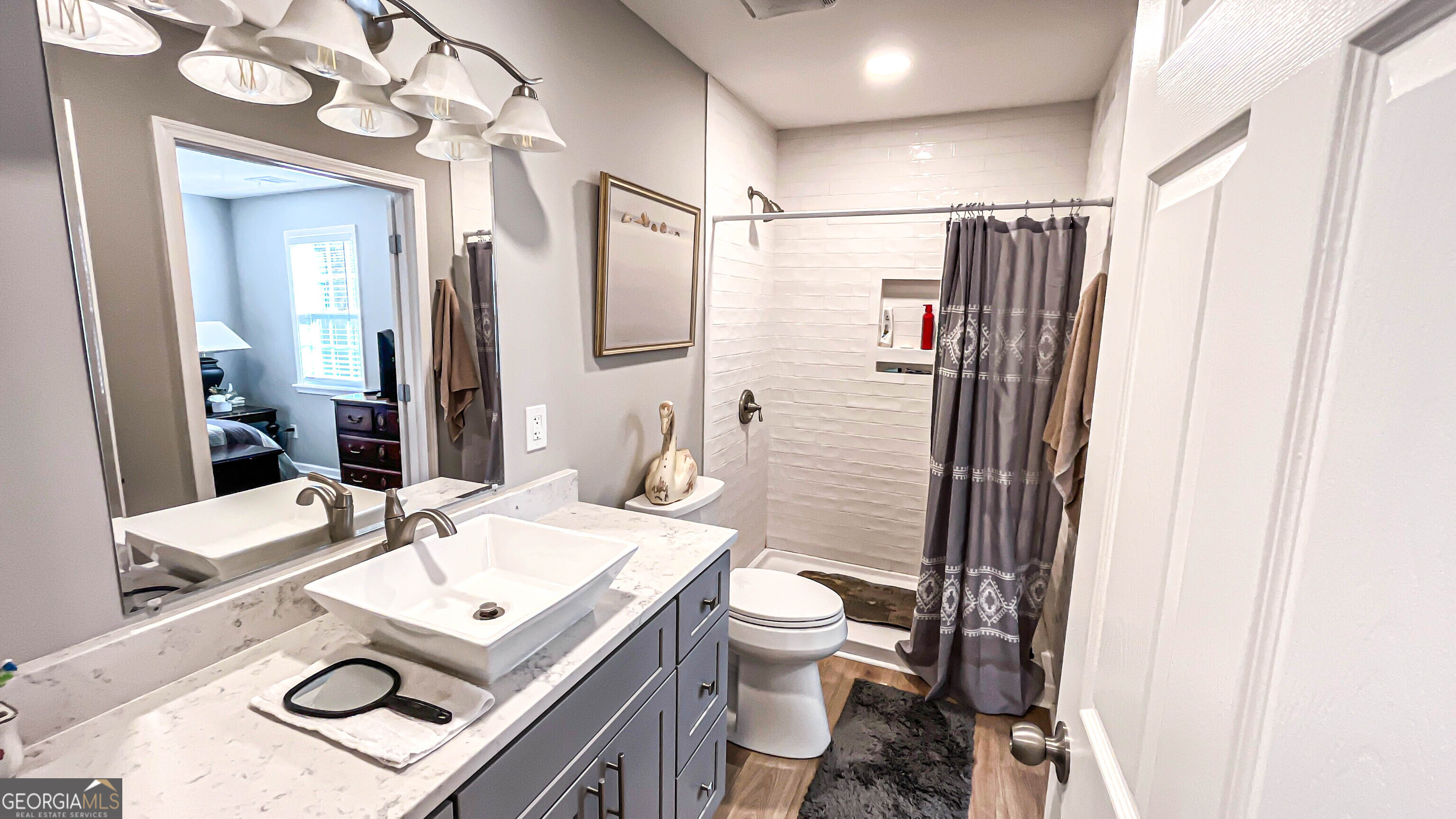 587 Highway 41 Milner, GA 30257 - Photo 109 of 172 a bathroom with a sink mirror vanity and toilet