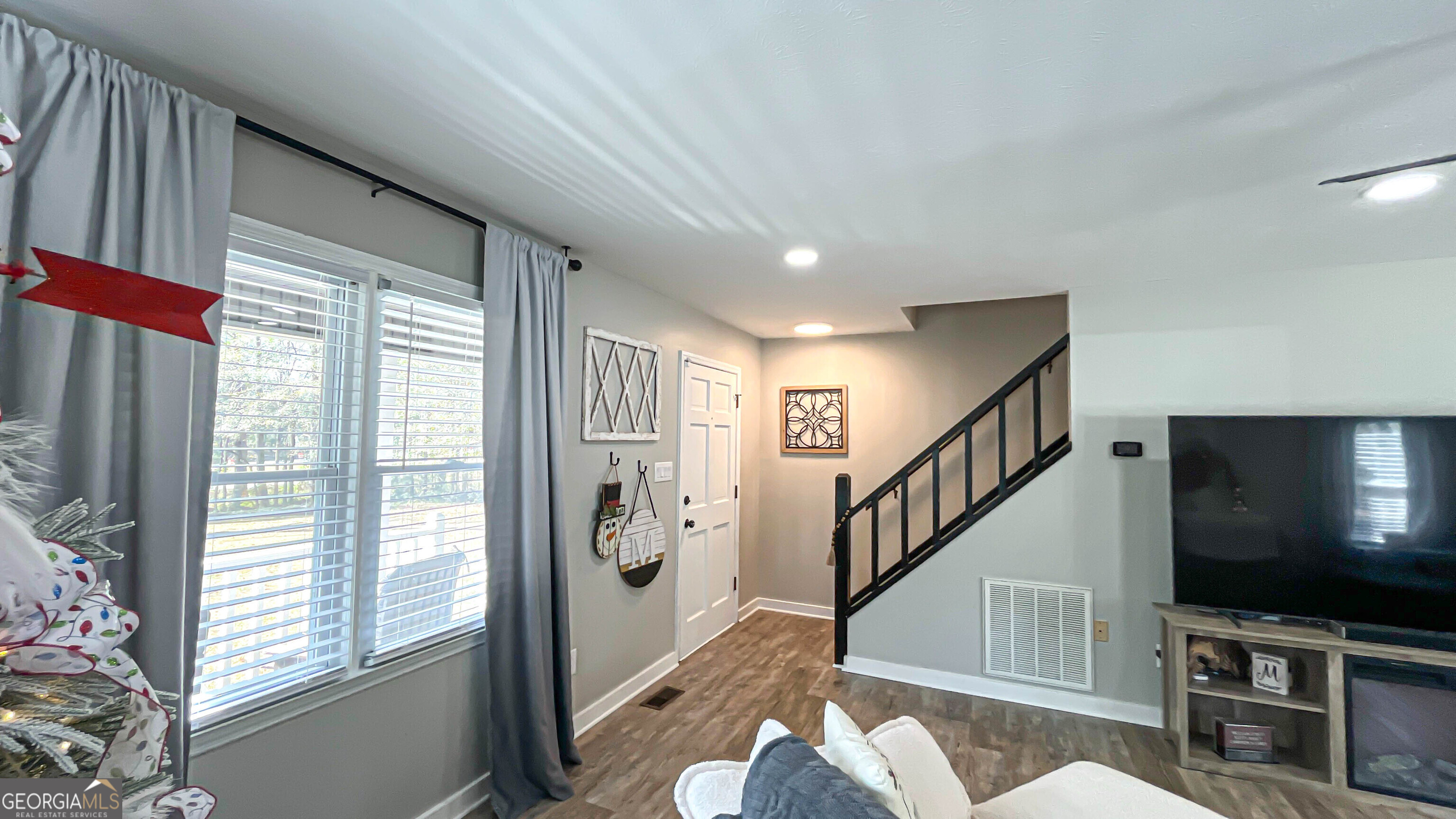 587 Highway 41 Milner, GA 30257 - Photo 21 of 172 a living room with furniture tv and wooden floor
