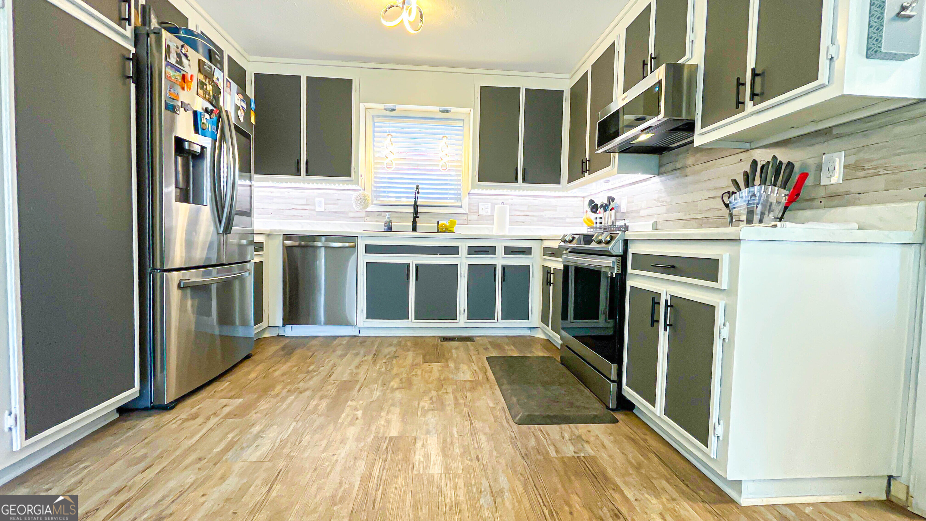 587 Highway 41 Milner, GA 30257 - Photo 36 of 172 a kitchen with stainless steel appliances granite countertop a refrigerator and a sink